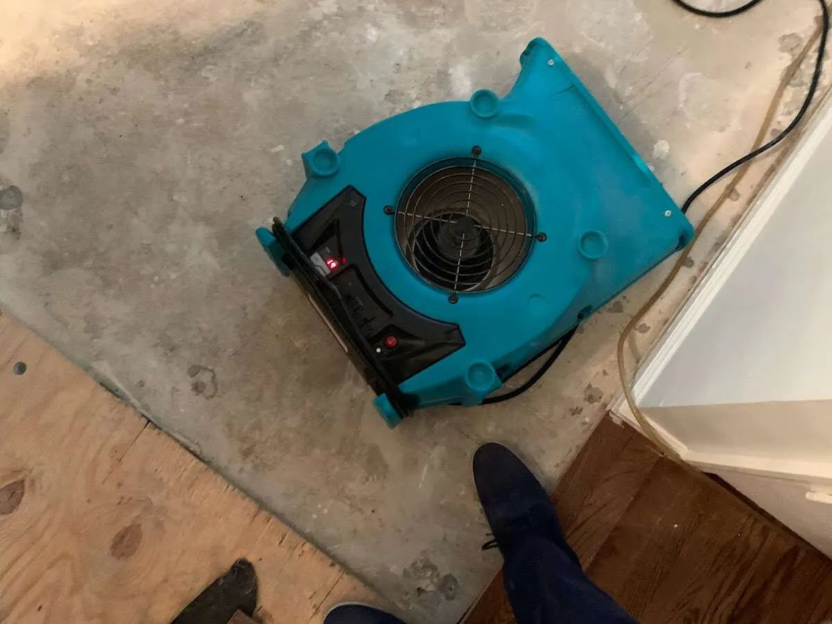 Air mover drying subfloor during Commercial Water Damage Restoration in Pembroke Park